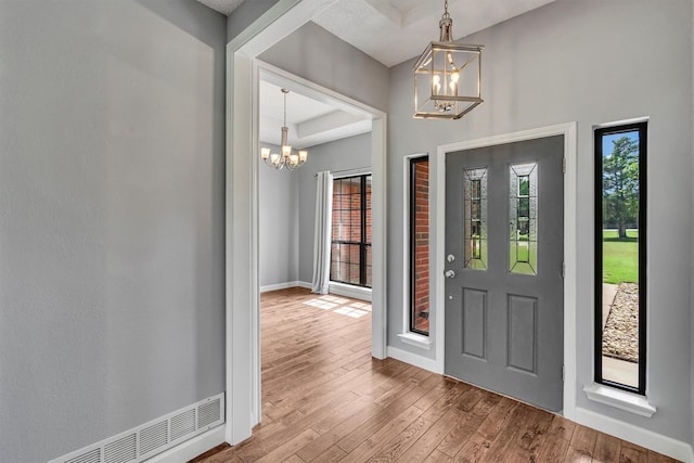 2310 N Walnut Grove Rd, Midlothian, TX 76065 - entryway with a chandelier, healthy amount of natural light, wood-type flooring, and baseboards