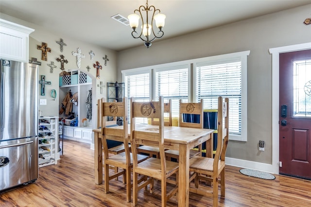 395 Yacht Cb Rd, Oak Point, TX 75068 - dining room featuring a chandelier, light wood finished floors, and baseboards