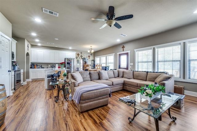 395 Yacht Cb Rd, Oak Point, TX 75068 - living area with light wood-type flooring, a ceiling fan, recessed lighting, a chandelier, and arched walkways