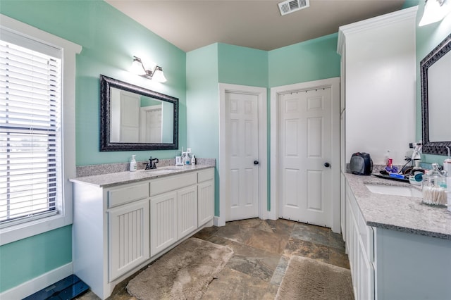 395 Yacht Cb Rd, Oak Point, TX 75068 - full bath featuring stone finish floors, two vanities, and baseboards