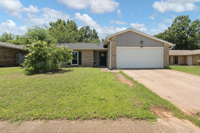 7504 Kingsmill Ter, Fort Worth, TX 76112 - view of front of home featuring an attached garage, brick siding, a front lawn, and driveway