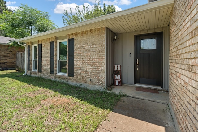 7504 Kingsmill Ter, Fort Worth, TX 76112 - property entrance with brick siding and a lawn