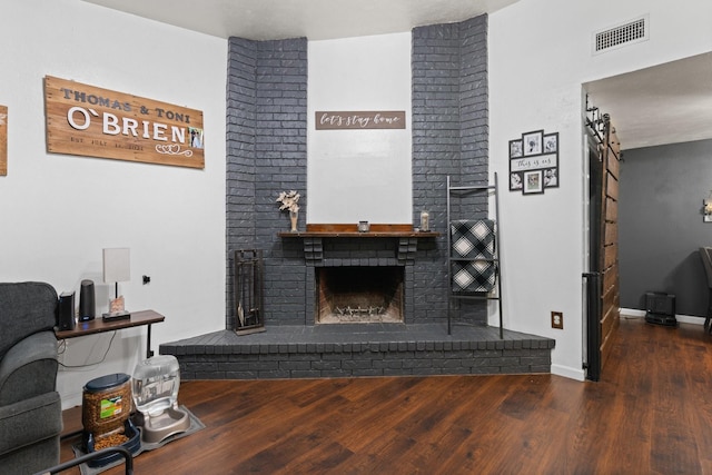 7504 Kingsmill Ter, Fort Worth, TX 76112 - living room featuring a brick fireplace, wood finished floors, and baseboards