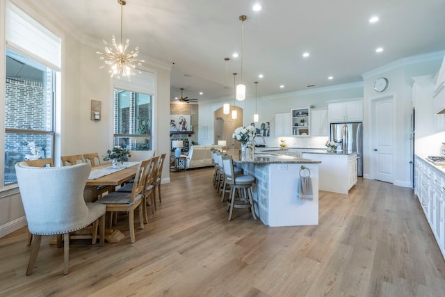3340 Pleasantville Rd, Midlothian, TX 76065 - kitchen featuring a kitchen island, stainless steel fridge with ice dispenser, ornamental molding, arched walkways, and recessed lighting