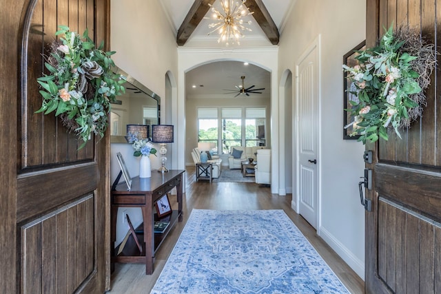 3340 Pleasantville Rd, Midlothian, TX 76065 - foyer with arched walkways, dark wood-type flooring, a ceiling fan, a chandelier, and ornamental molding