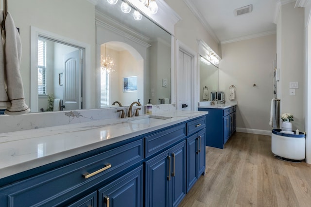 3340 Pleasantville Rd, Midlothian, TX 76065 - full bathroom with two vanities, wood finished floors, crown molding, and a chandelier