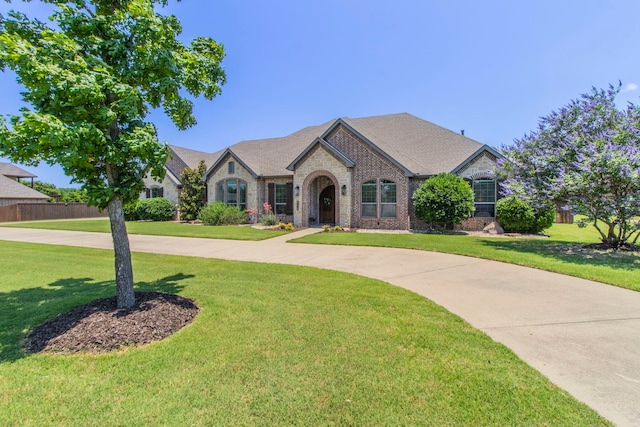 3340 Pleasantville Rd, Midlothian, TX 76065 - french country home featuring a front lawn, brick siding, and stone siding