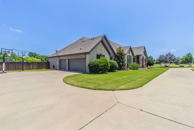 3340 Pleasantville Rd, Midlothian, TX 76065 - view of home's exterior featuring stone siding, concrete driveway, an attached garage, and brick siding