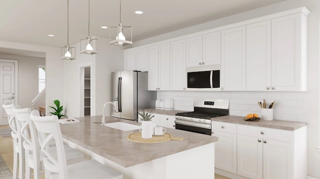 1618 Mint Rd, Argyle, TX 76226 - kitchen featuring appliances with stainless steel finishes, backsplash, a kitchen island with sink, white cabinets, and recessed lighting
