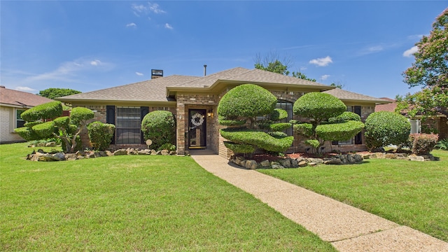 411 Roaring Springs Dr, Allen, TX 75002 - view of front facade featuring a front yard, roof with shingles, a chimney, and brick siding