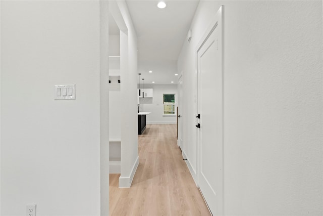 4523 Wahoo St, Dallas, TX 75210 - hallway featuring light wood-type flooring, recessed lighting, and baseboards