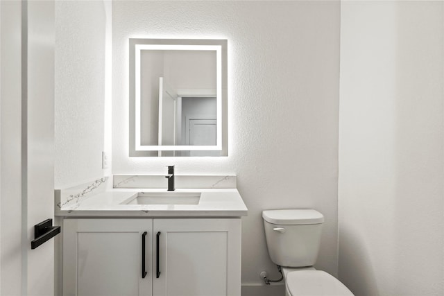 4523 Wahoo St, Dallas, TX 75210 - bathroom featuring toilet, vanity, and a textured wall