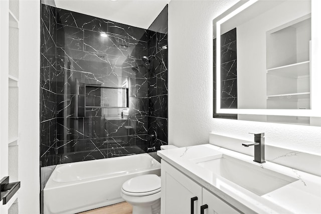 4523 Wahoo St, Dallas, TX 75210 - full bathroom featuring a textured wall, vanity, toilet, and washtub / shower combination
