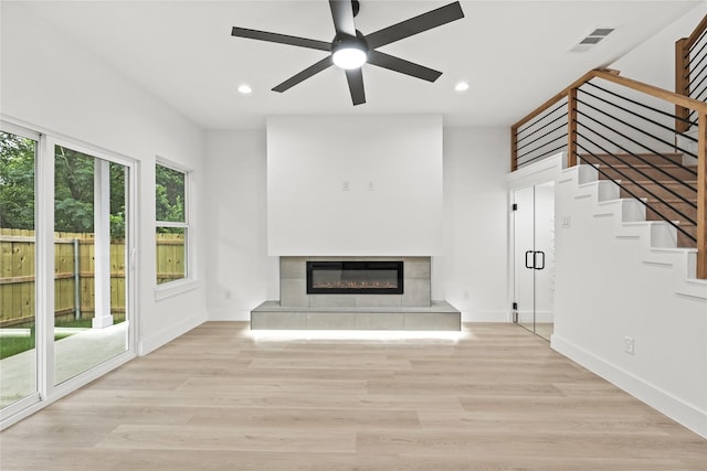 4523 Wahoo St, Dallas, TX 75210 - unfurnished living room featuring a glass covered fireplace, stairway, recessed lighting, ceiling fan, and baseboards