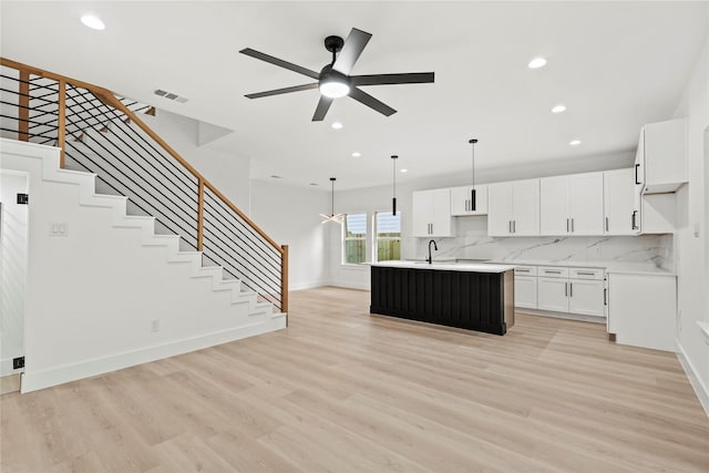 4523 Wahoo St, Dallas, TX 75210 - kitchen featuring light countertops, decorative backsplash, a ceiling fan, recessed lighting, and light wood finished floors