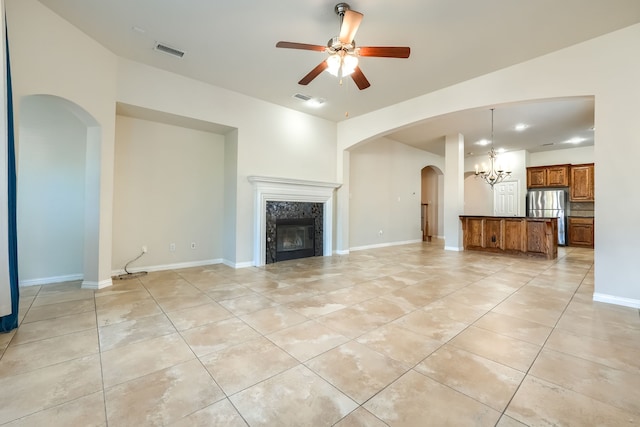 2128 Chambers Dr, Allen, TX 75013 - unfurnished living room with light tile patterned flooring, arched walkways, a fireplace, and a chandelier