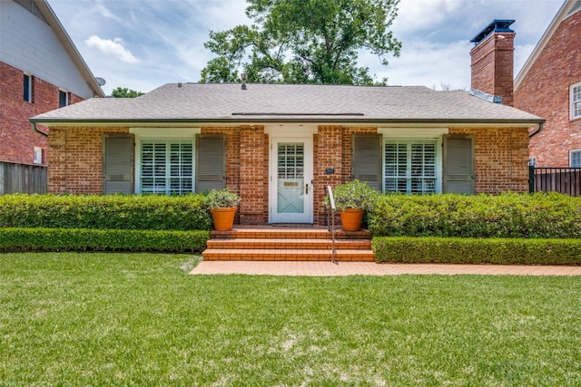 4229 Colgate Ave, University Park, TX 75225 - view of front facade featuring brick siding, a chimney, and roof with shingles
