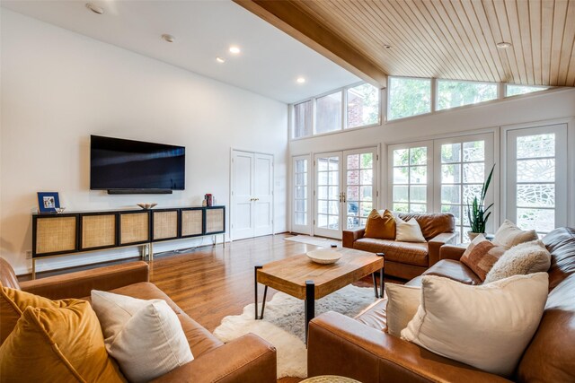 4229 Colgate Ave, University Park, TX 75225 - living area with beam ceiling, wood finished floors, healthy amount of natural light, recessed lighting, and high vaulted ceiling