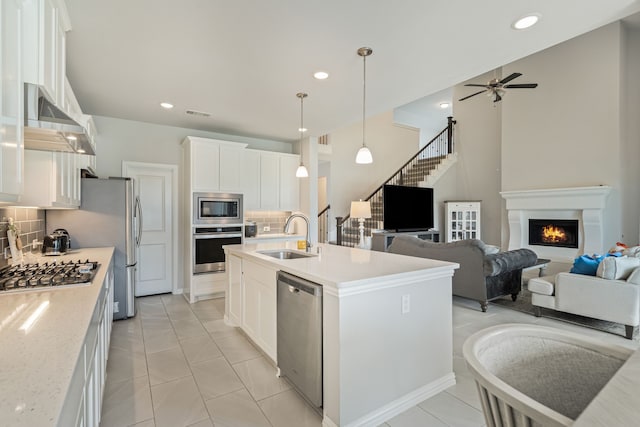 7020 Cross Point Ln, Little Elm, TX 76227 - kitchen featuring a sink, appliances with stainless steel finishes, ceiling fan, backsplash, and light countertops