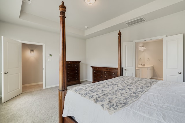 7020 Cross Point Ln, Little Elm, TX 76227 - bedroom with carpet, a raised ceiling, baseboards, and connected bathroom