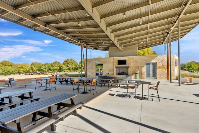 7020 Cross Point Ln, Little Elm, TX 76227 - view of patio / terrace featuring a fireplace, french doors, and outdoor dining space