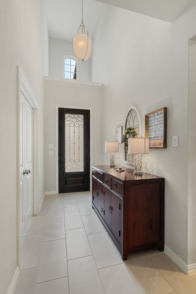 7020 Cross Point Ln, Little Elm, TX 76227 - entrance foyer featuring a towering ceiling, light tile patterned flooring, and baseboards