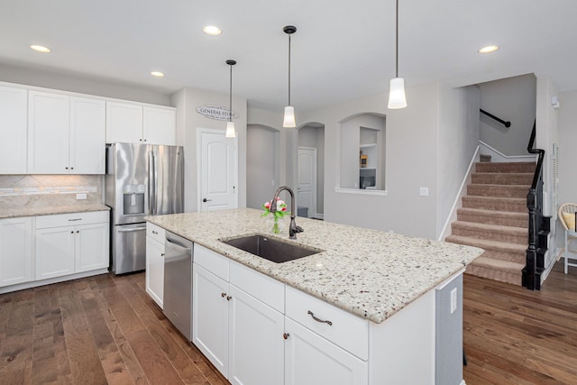 1205 Glacier Ct, Celina, TX 75009 - kitchen with stainless steel appliances, a sink, dark wood finished floors, recessed lighting, and hanging light fixtures