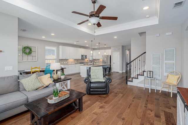 1205 Glacier Ct, Celina, TX 75009 - living room with a raised ceiling, a ceiling fan, wood finished floors, recessed lighting, and stairway