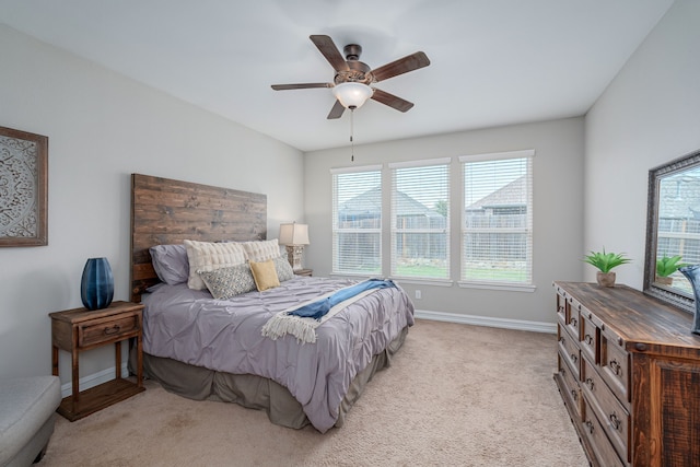 1205 Glacier Ct, Celina, TX 75009 - bedroom featuring multiple windows, light colored carpet, baseboards, and ceiling fan