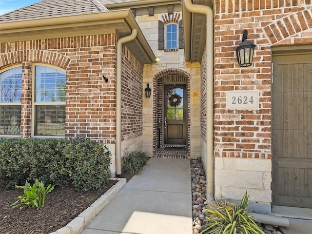 2624 Bellevue, The Colony, TX 75056 - doorway to property with brick siding, roof with shingles, and stone siding
