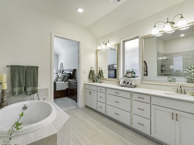 2624 Bellevue, The Colony, TX 75056 - ensuite bathroom with double vanity, a garden tub, a shower stall, lofted ceiling, and recessed lighting