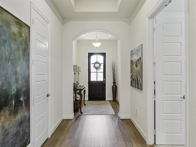 2624 Bellevue, The Colony, TX 75056 - entrance foyer with arched walkways, dark wood-style floors, and baseboards