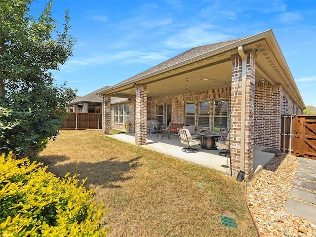 2624 Bellevue, The Colony, TX 75056 - rear view of property with brick siding, a patio area, and a gate