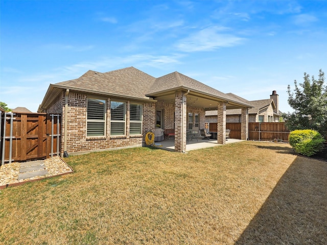 2624 Bellevue, The Colony, TX 75056 - rear view of property featuring brick siding, a patio, a gate, and roof with shingles