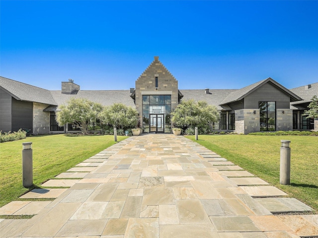 2624 Bellevue, The Colony, TX 75056 - view of front of home featuring a front yard, roof with shingles, and stone siding