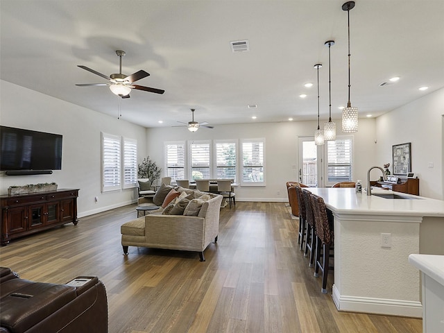 2624 Bellevue, The Colony, TX 75056 - living room with dark wood-type flooring, a ceiling fan, healthy amount of natural light, baseboards, and recessed lighting