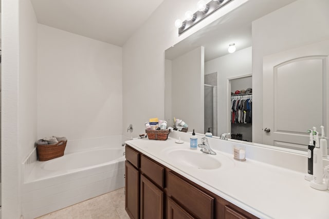 1615 White Mountain Way, Princeton, TX 75407 - full bath featuring vanity, a bath, a stall shower, a spacious closet, and tile patterned floors