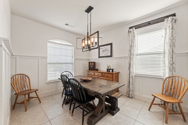 1615 White Mountain Way, Princeton, TX 75407 - dining room with a decorative wall, light tile patterned floors, wainscoting, and a chandelier