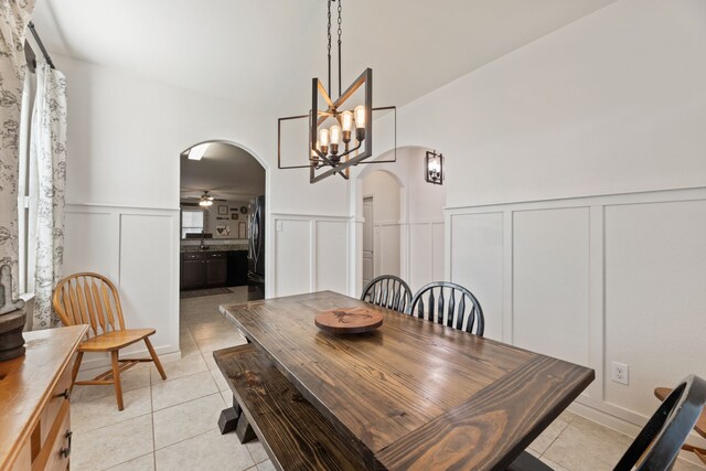 1615 White Mountain Way, Princeton, TX 75407 - dining room featuring arched walkways, a decorative wall, light tile patterned floors, a wainscoted wall, and ceiling fan