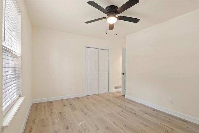 2810 Altman Dr, Irving, TX 75062 - unfurnished bedroom with light wood-style flooring, a closet, baseboards, and a ceiling fan