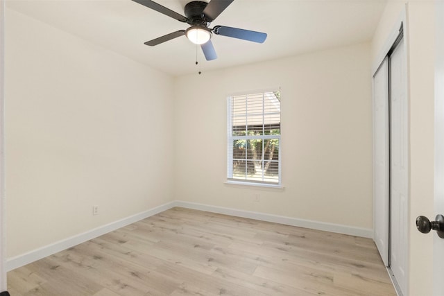 2810 Altman Dr, Irving, TX 75062 - unfurnished bedroom featuring light wood-style flooring, a closet, baseboards, and ceiling fan