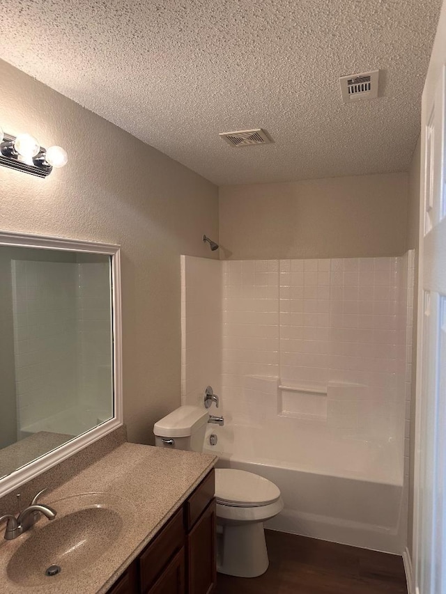 195 Rolling Ct, Lancaster, TX 75146 - full bath with vanity, wood finished floors, a textured ceiling, toilet, and washtub / shower combination