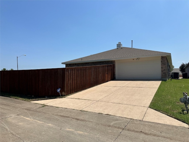 195 Rolling Ct, Lancaster, TX 75146 - view of property exterior featuring driveway, an attached garage, central AC unit, and brick siding