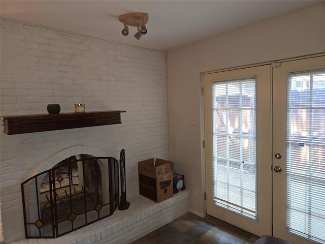 5924 Birchbrook Dr Unit 121, Dallas, TX 75206 - unfurnished living room featuring french doors and brick wall
