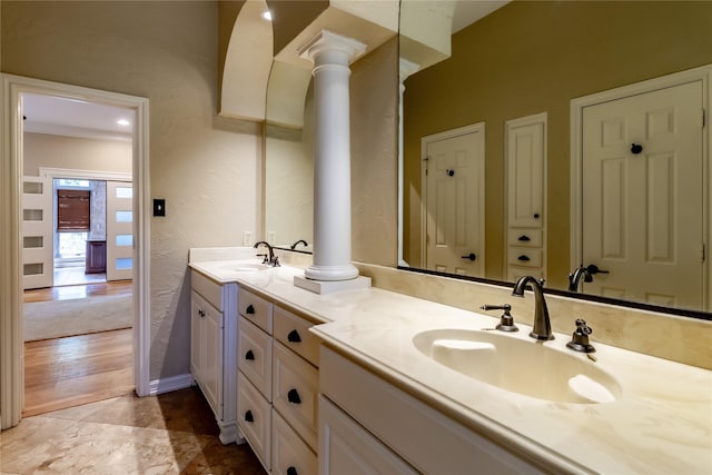 2310 Castle Rock Rd, Arlington, TX 76006 - bathroom with double vanity, ornate columns, and a textured wall