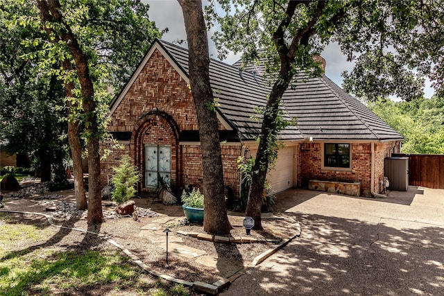 2310 Castle Rock Rd, Arlington, TX 76006 - view of front of home featuring brick siding, concrete driveway, and a garage