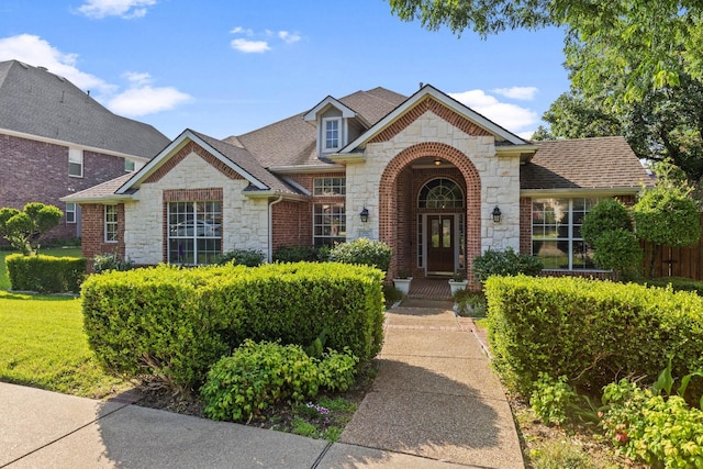 4206 Creekbluff Dr, Rowlett, TX 75088 - view of front of home featuring stone siding, a shingled roof, and brick siding