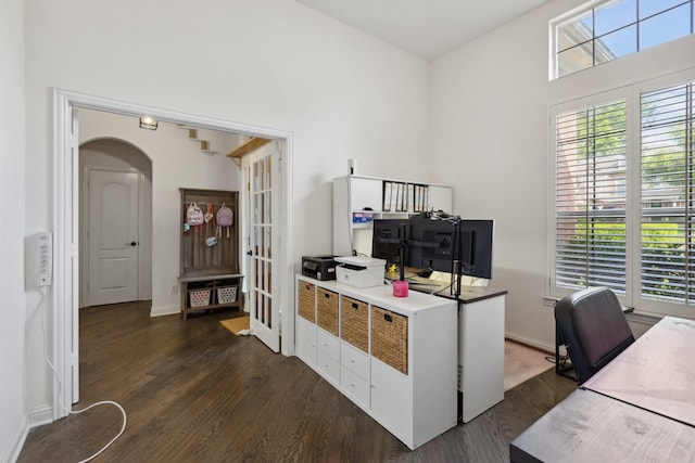 4206 Creekbluff Dr, Rowlett, TX 75088 - office area featuring dark wood-type flooring, arched walkways, a high ceiling, and baseboards