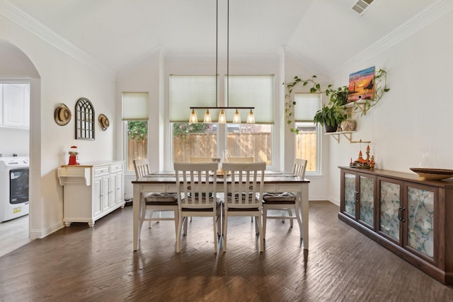 4206 Creekbluff Dr, Rowlett, TX 75088 - dining area with washer / clothes dryer, lofted ceiling, arched walkways, crown molding, and dark wood-style floors