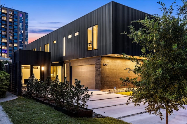 5029 Pershing St, Dallas, TX 75206 - contemporary home with an attached garage, brick siding, and driveway